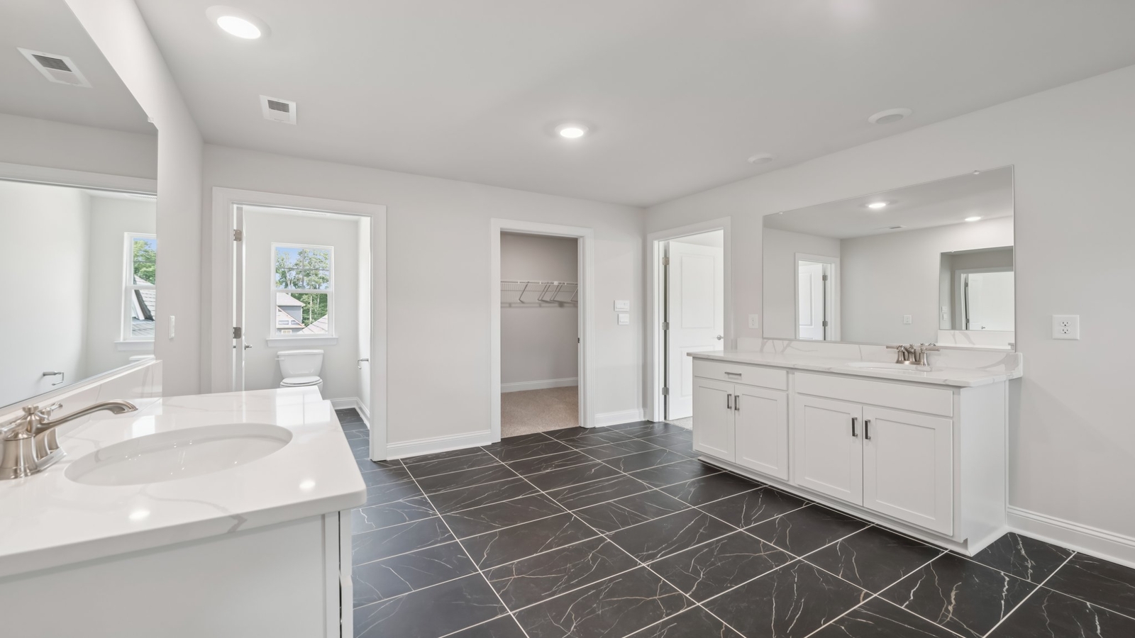 Primary en-suite bathroom in this D.R. Horton New Home featuring dual sinks, expansive vanity, shower-tub, Walk-in Closet