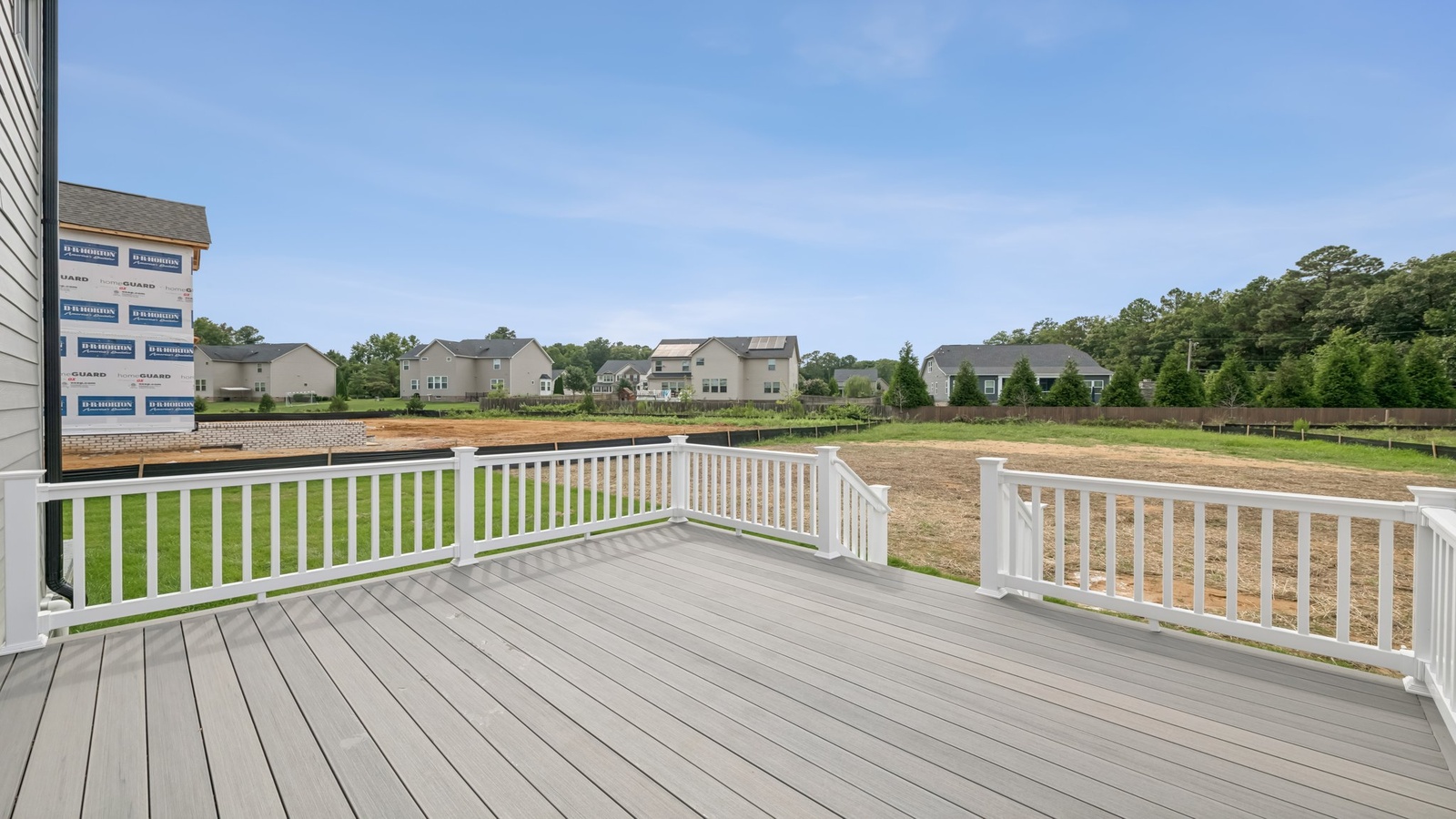 Backyard with deck area offering room for seating, grill setup, and a transition from indoor to outdoor living