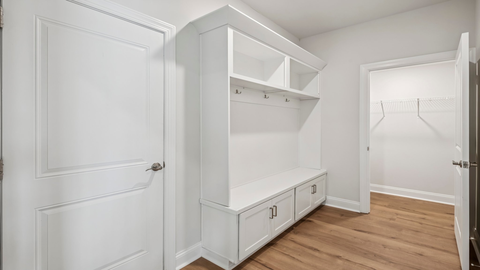 Functional mudroom design with garage-kitchen acess in D.R. Horton New Build Home located in a planned community