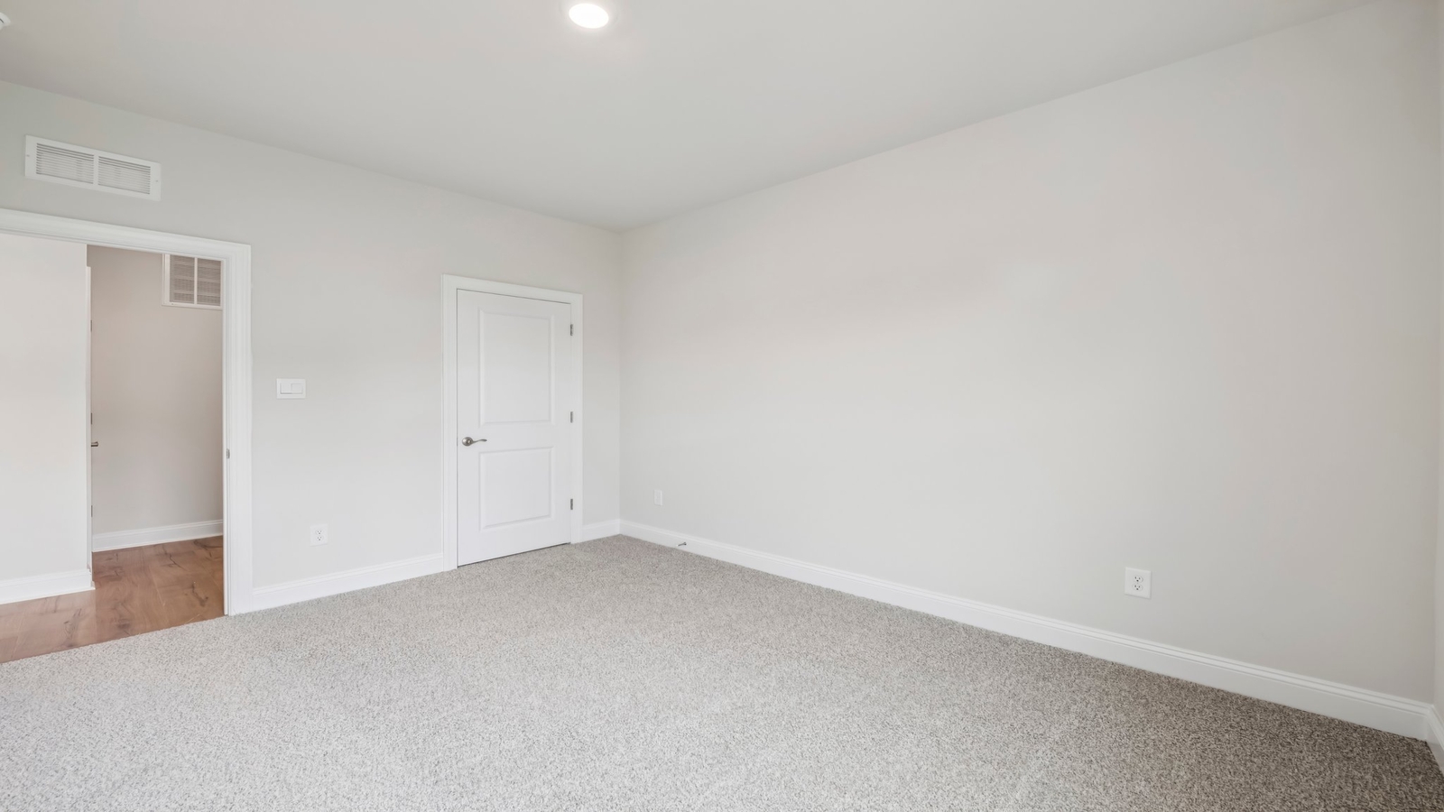 Owner’s suite offers natural window light, a spa-inspired en-suite bathroom, and a walk-in closet for everyday comfort