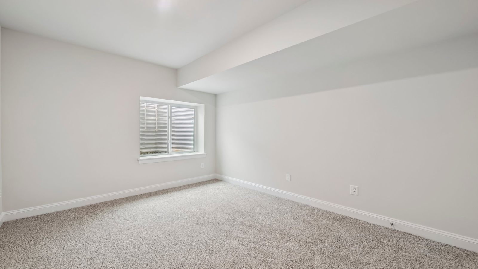 Basement-level bedroom with soft natural lighting, closets, stairs to main access in Sheppard Mill