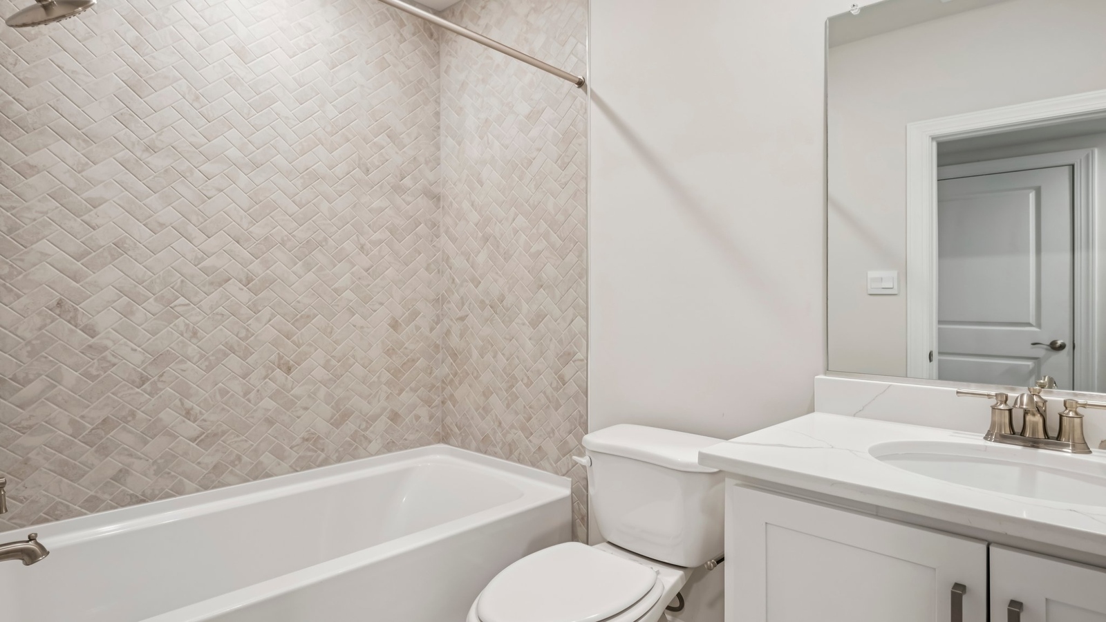 Family bathroom with quality vanity, tub-shower combo, storage under sink in Sheppard Mill  by D.R. Horton