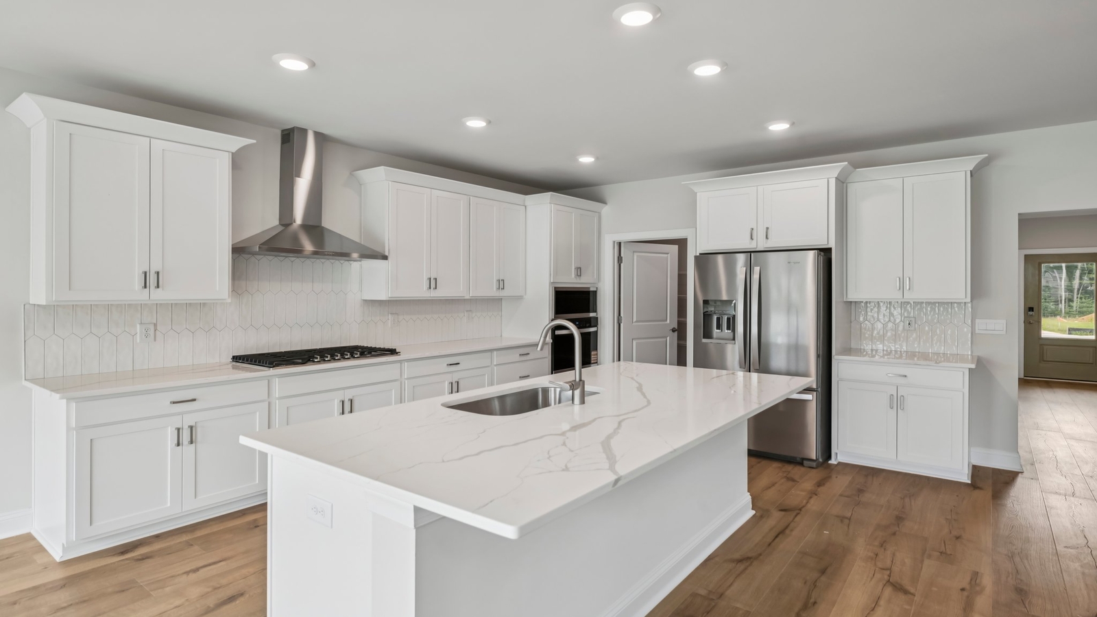 Kitchen, dining, and living areas form one flowing main living space designed for comfort at Sheppard Mill