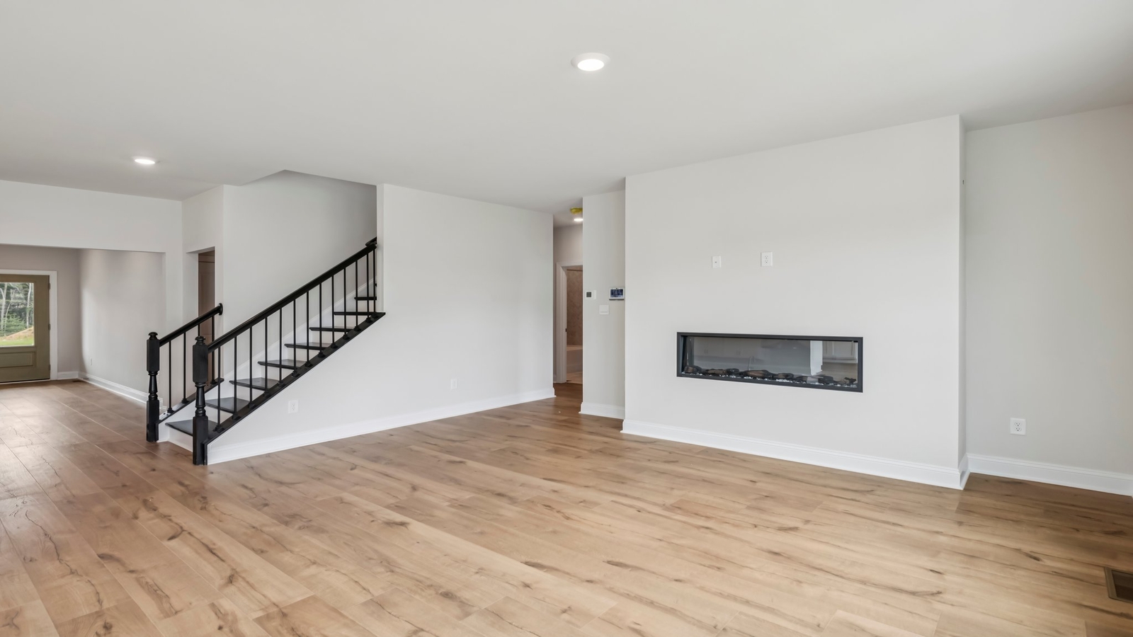 Main living area in Sheppard Mill with electric fireplace for flow between dining, kitchen, and living room