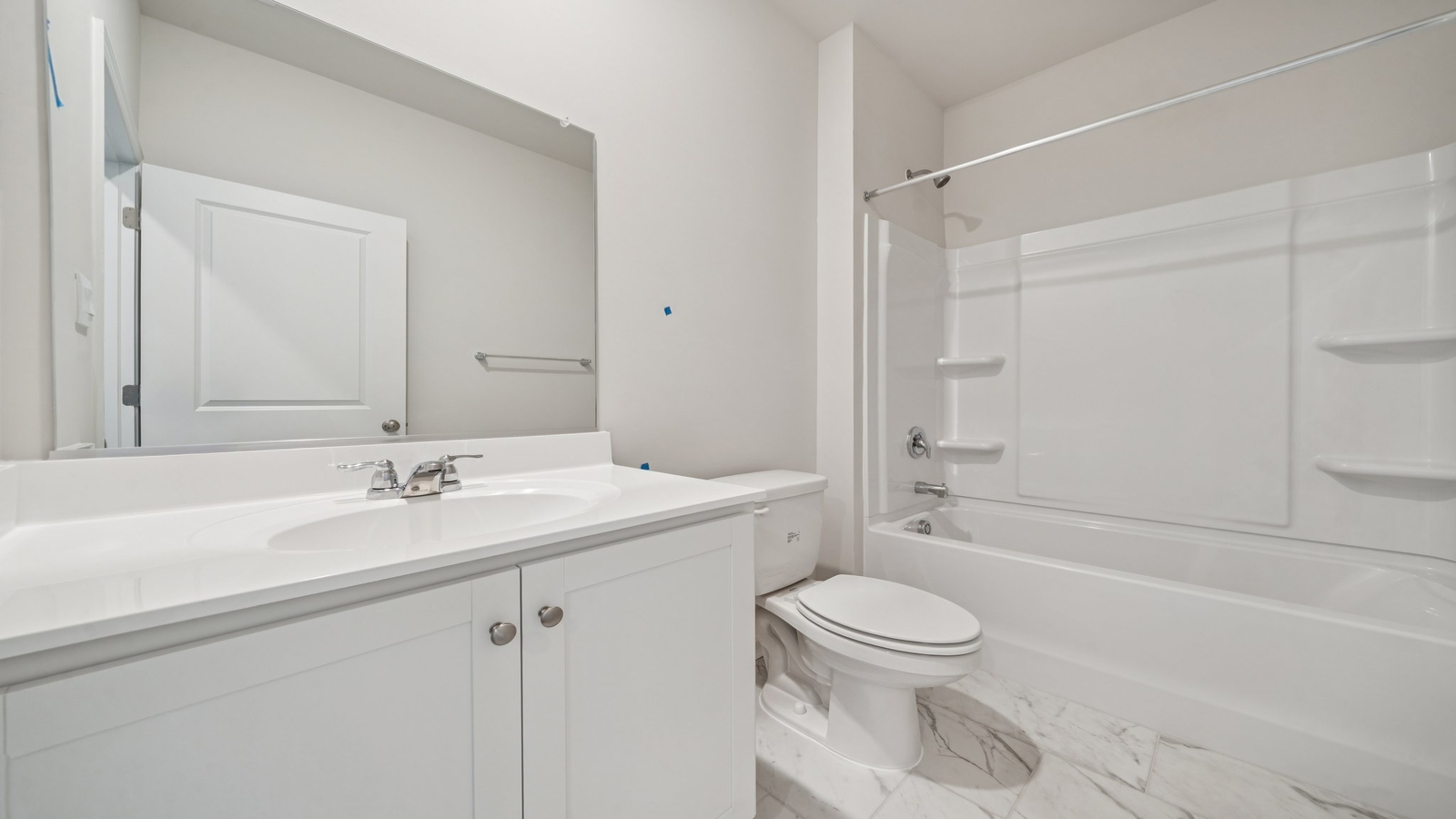 Family bathroom with tub-shower combo and bright lighting