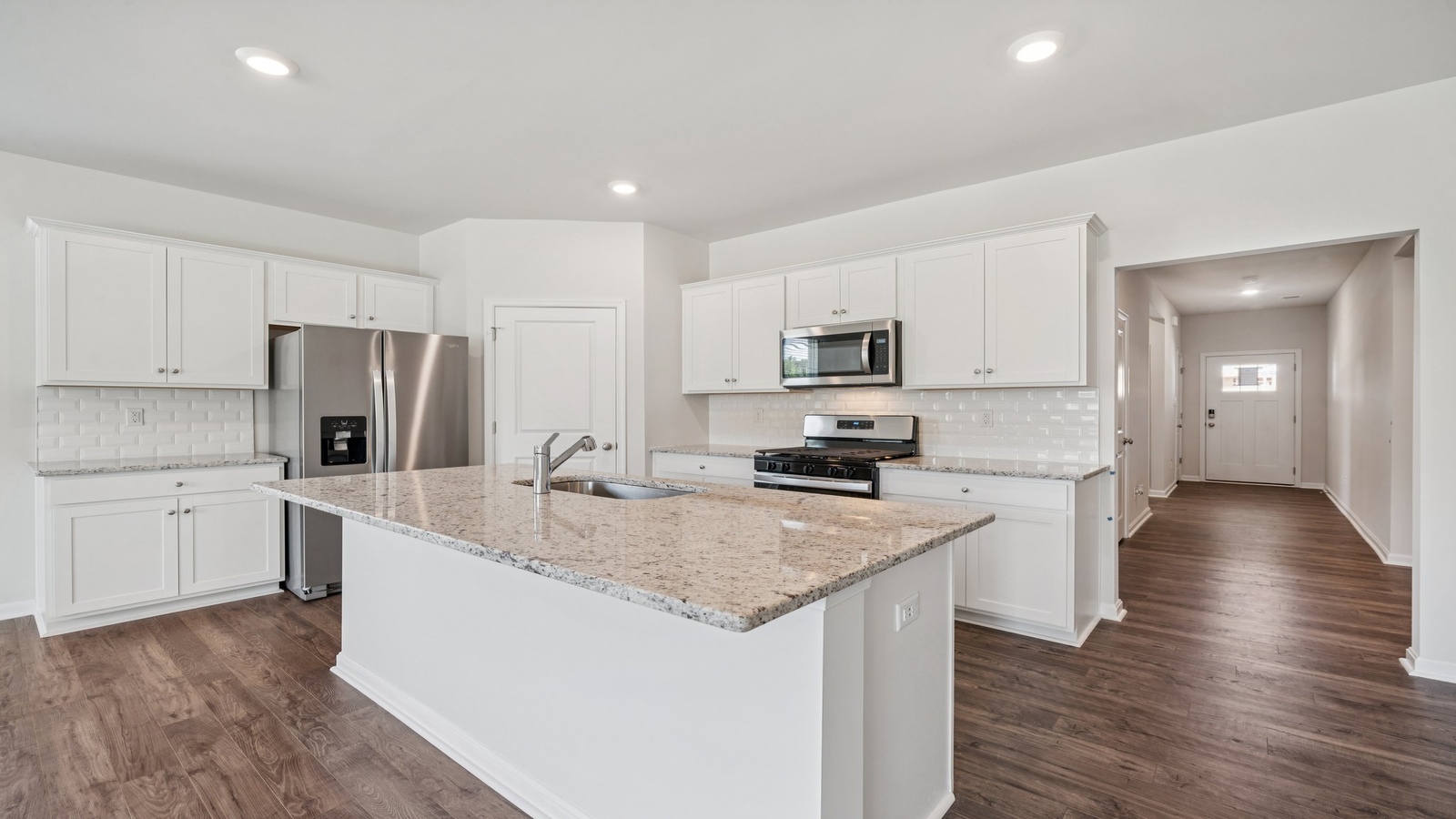 Kitchen-dining-family room blend together with quality flooring, access to dining nook-living areas, and backyard views in New Home