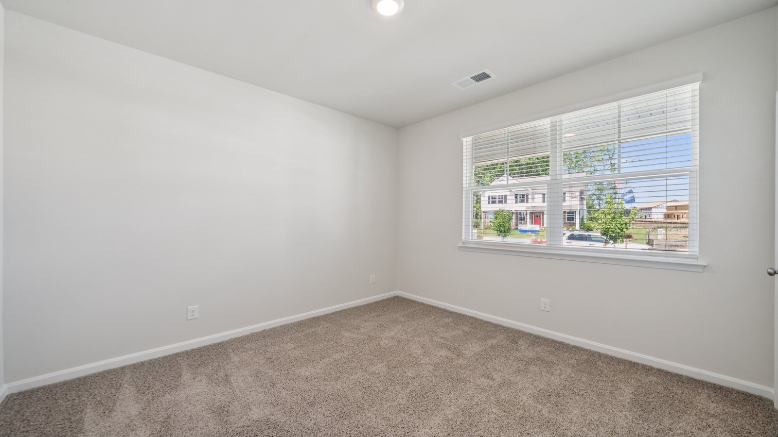 Secondary Bedroom in this New Home includes stellar carpet, bright window light, closet, ideal for guest or child use