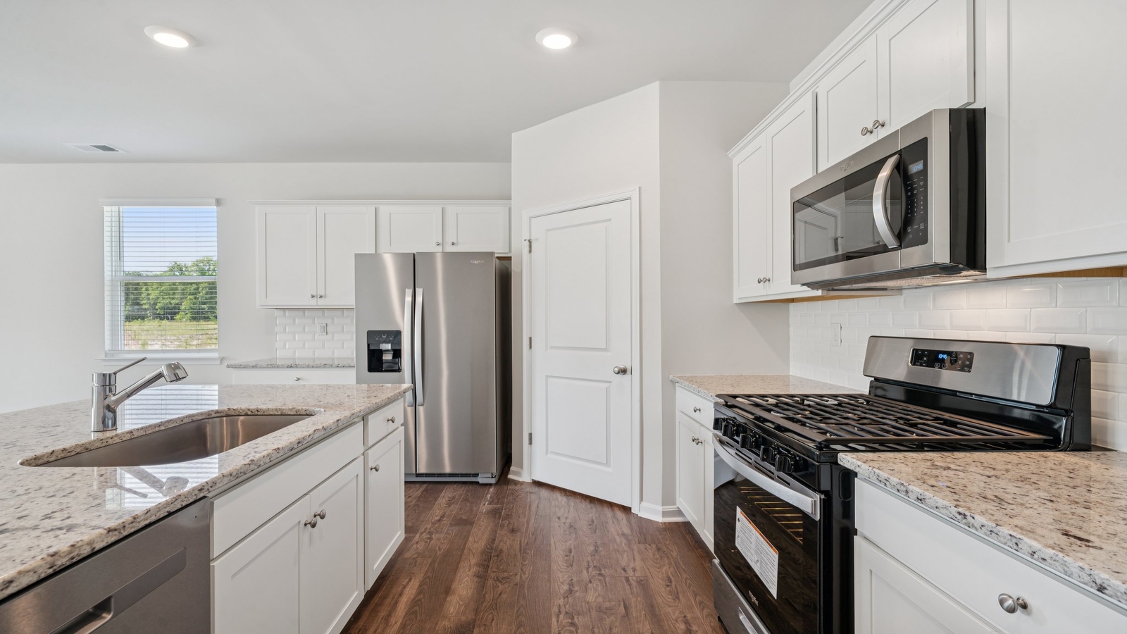 Kitchen island with new appliance suite and cabinet options overlooking the living-dining room at Smith Farm