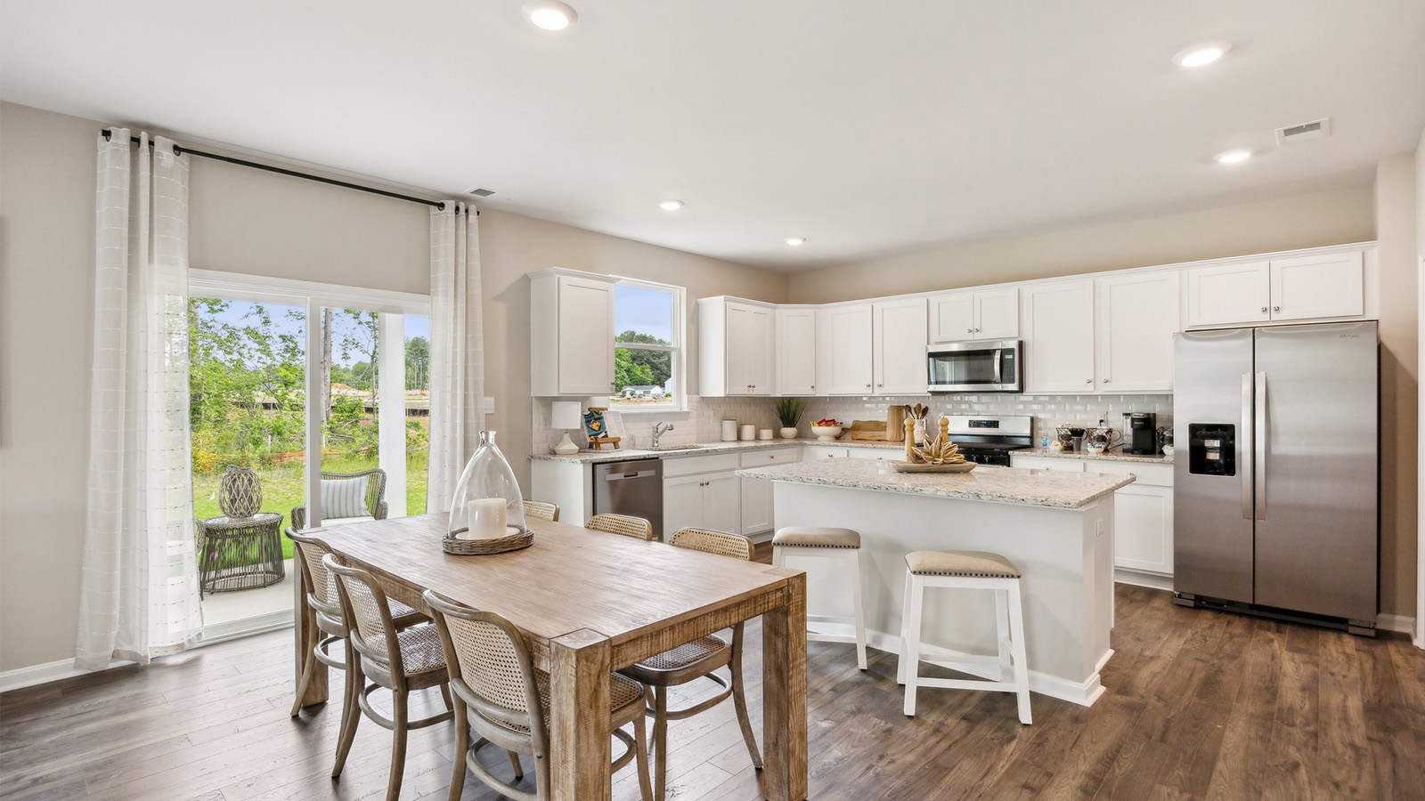 Main living space blends seamlessly, kitchen to family room with upgraded design and space for entertaining or everyday living