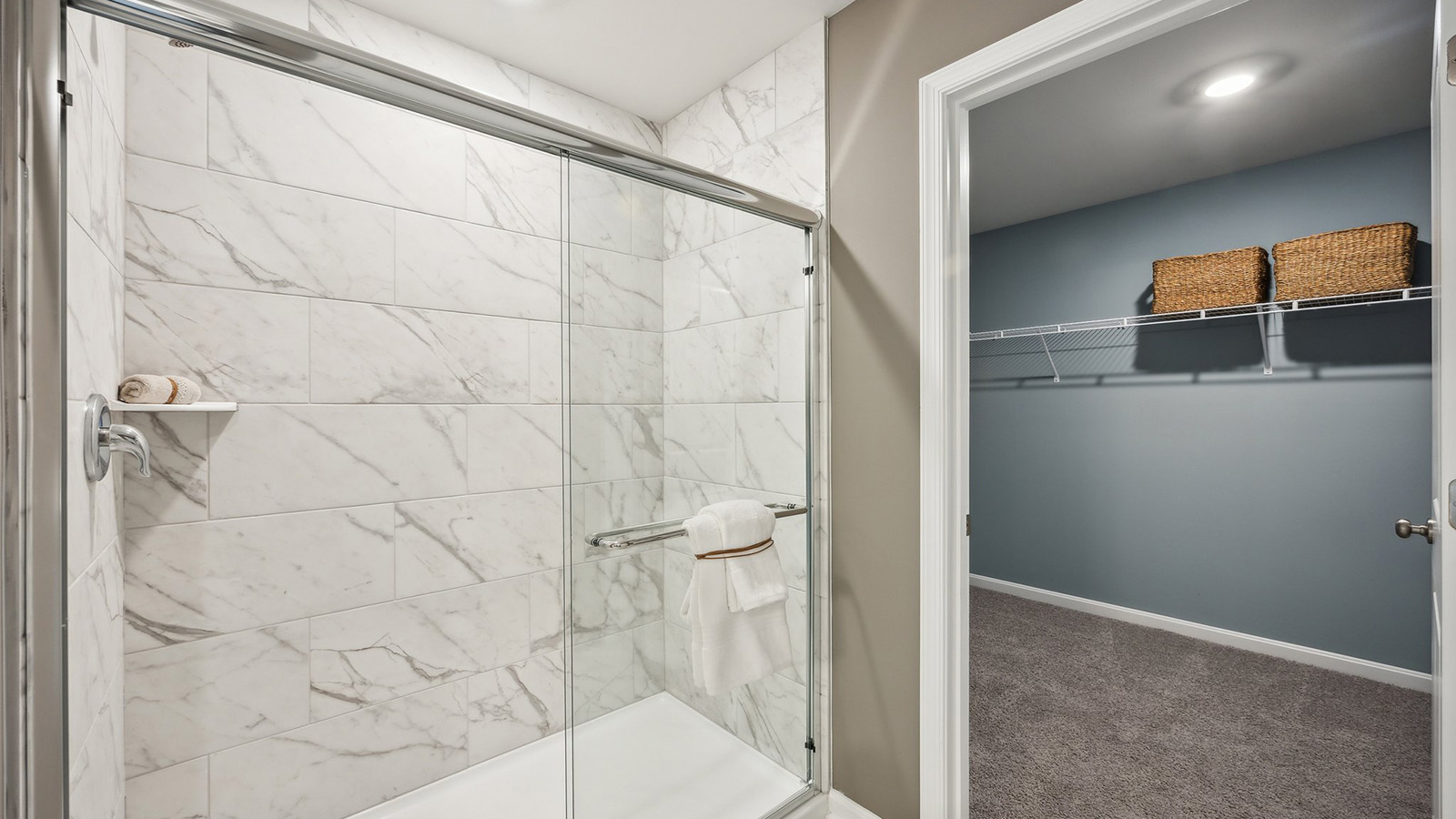 Primary bathroom in this New Build Home includes extended vanity, quality cabinets, walk-in closet and spa-inspired design