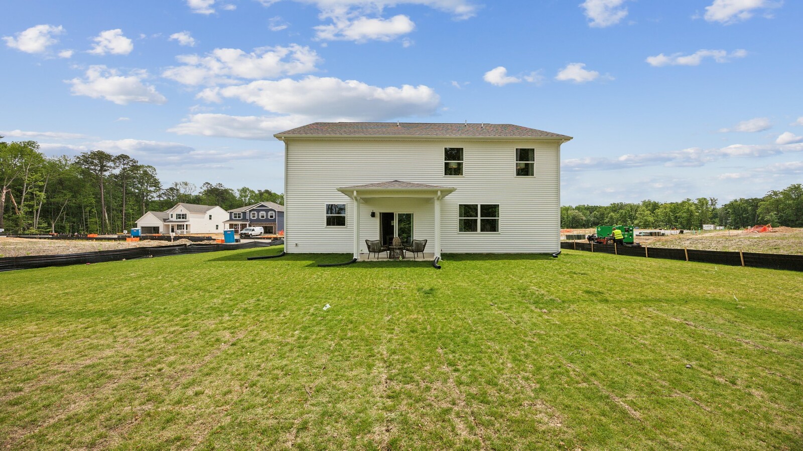 Backyard with covered patio area offering room for seating, grill setup, enjoying indoor to outdoor life grassy areas