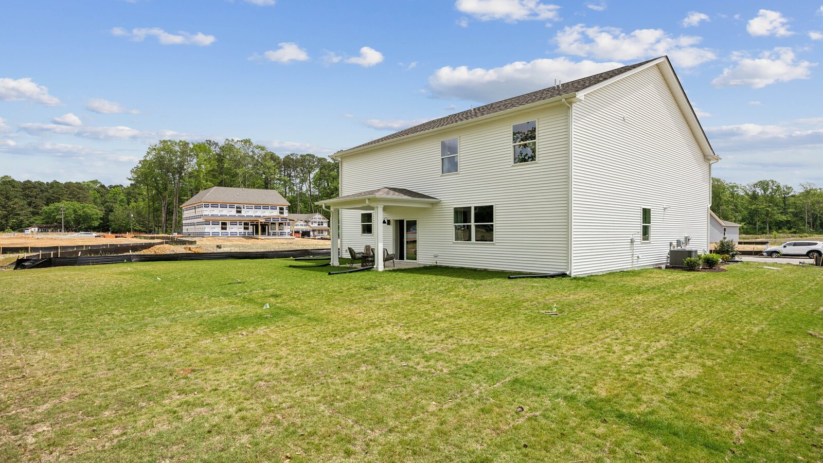 Covered rear patio in this D.R. Horton New Home with outdoor living and private backyard views from the Open Concept layout