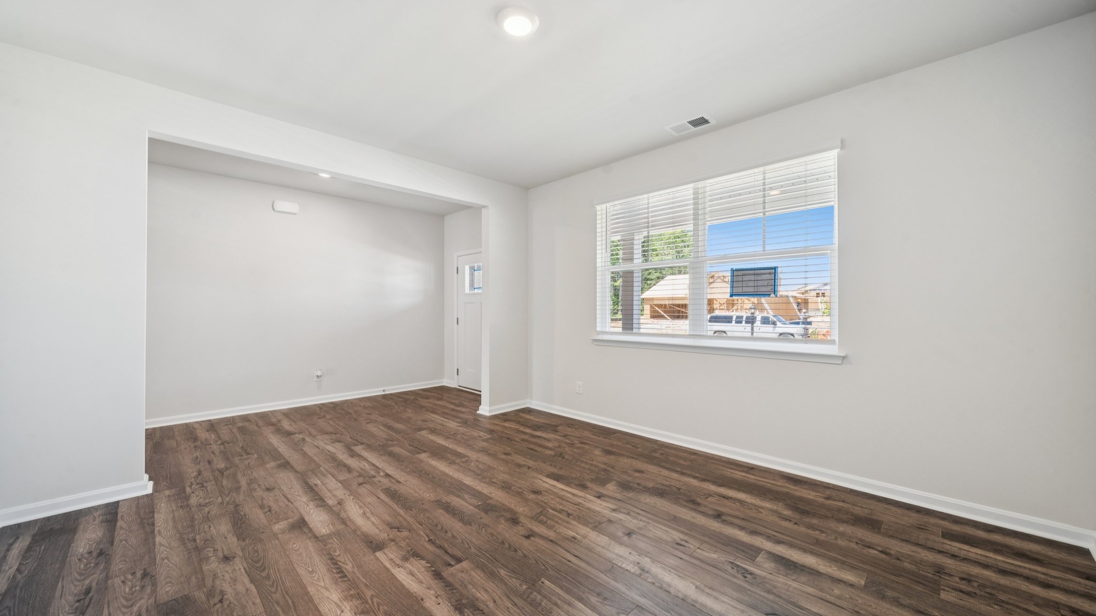 Smith Farm foyer with clean trim, rectangular entry light, and directional hallway access