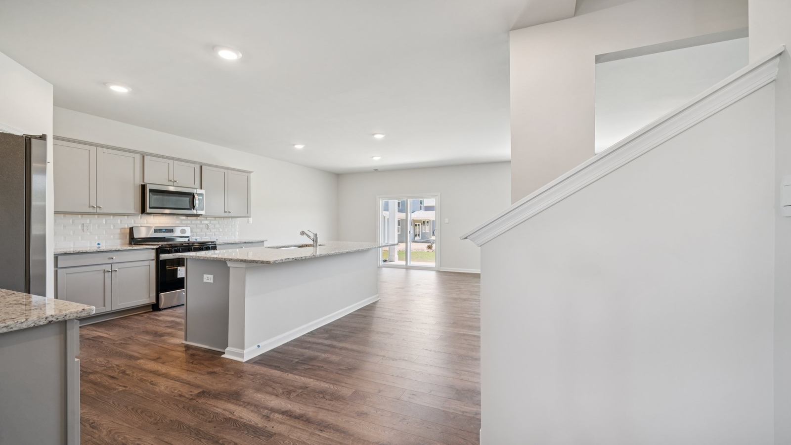 Our kitchen features a large island with seating, pantry, New appliance suite, stairs access, Modern Design finishes