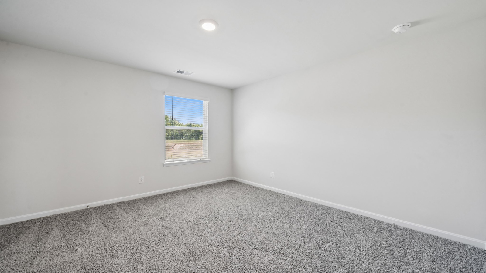 Primary bedroom in this New Home features ample space, double windows, quality carpet, a Walk-in Closet, private En-Suite Bath