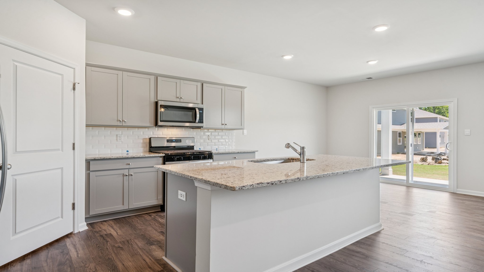 Kitchen island with seating, pantry, prep zones, featuring a New appliance suite, near dining, backyard and living areas