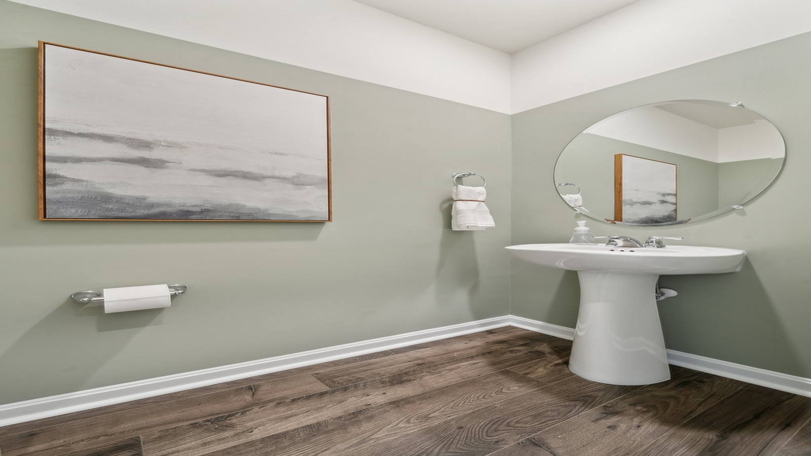 Half bath with door opening to hallway, pedestal sink, mirror visible with shiny faucet in Smith Farm