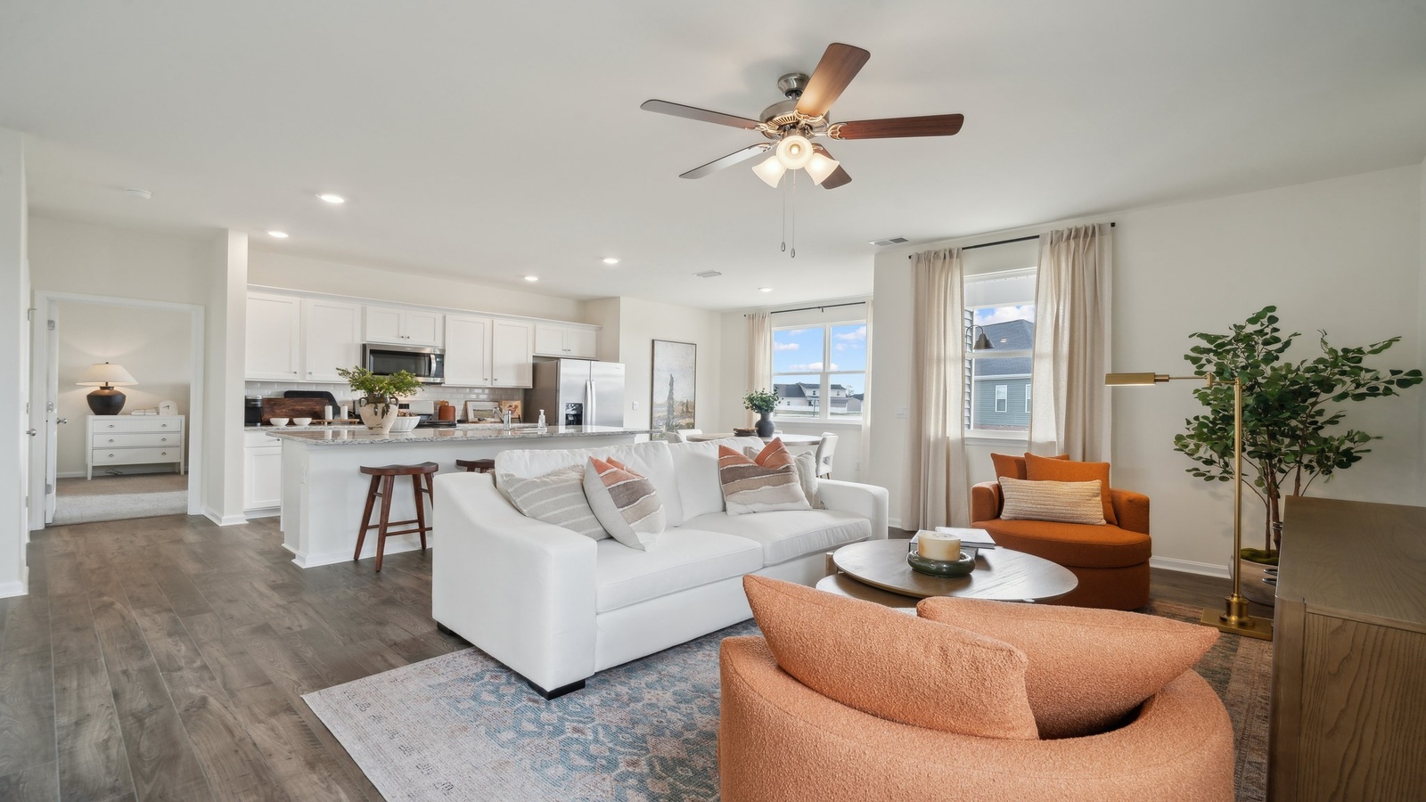 Modern living room in New Home offers backyard visibility, dining and kitchen access Smith Farm