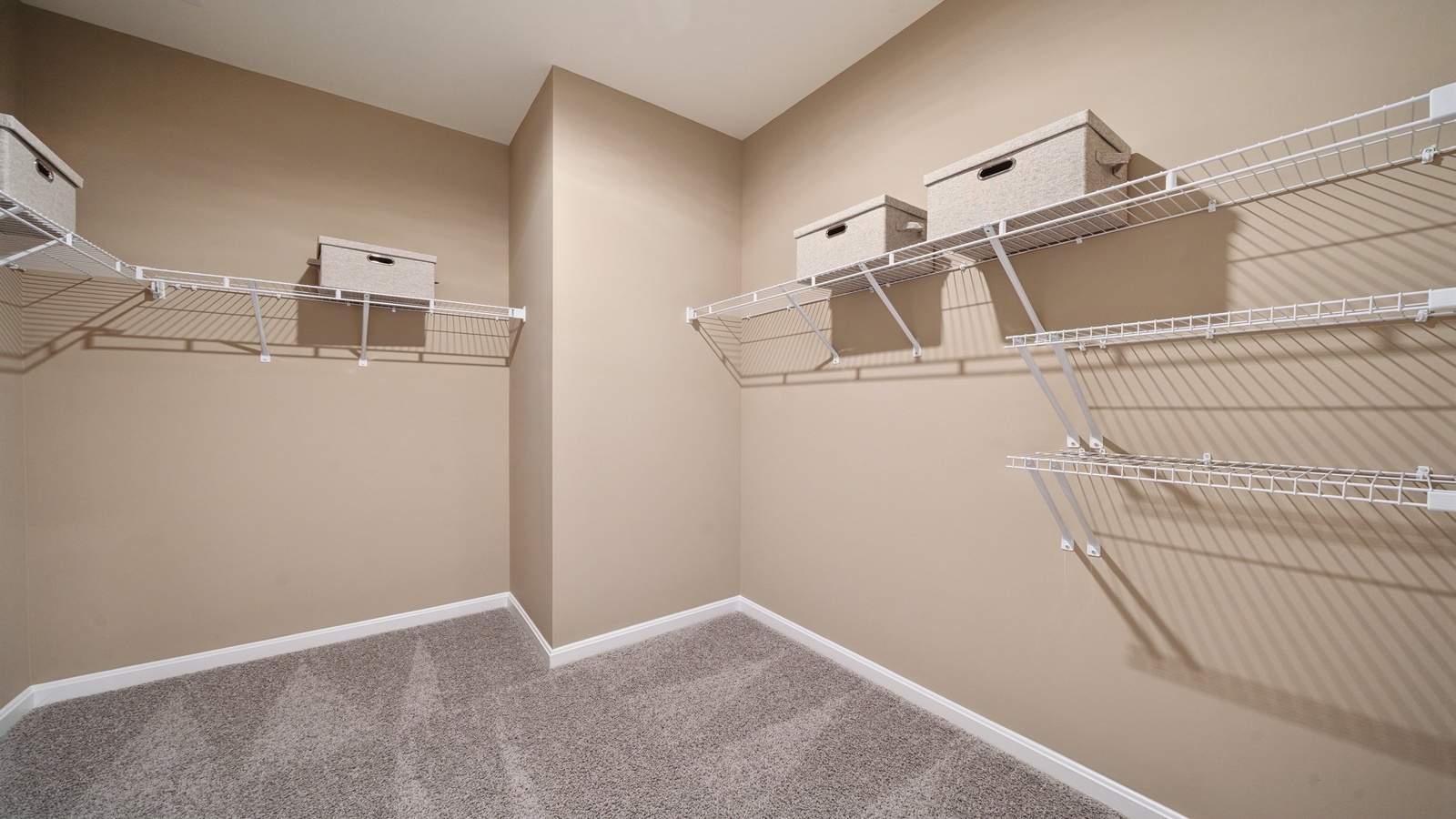 Primary bedroom walk-in closet enjoys ample space for clothes and accessories in Smith Farm