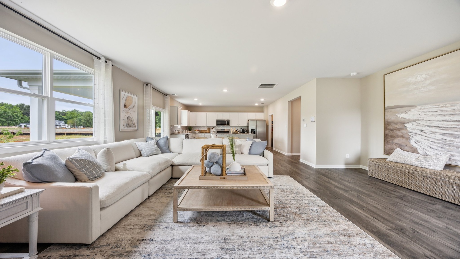 Modern living room in new home offers backyard visibility, dining and kitchen access Green Spring Estates