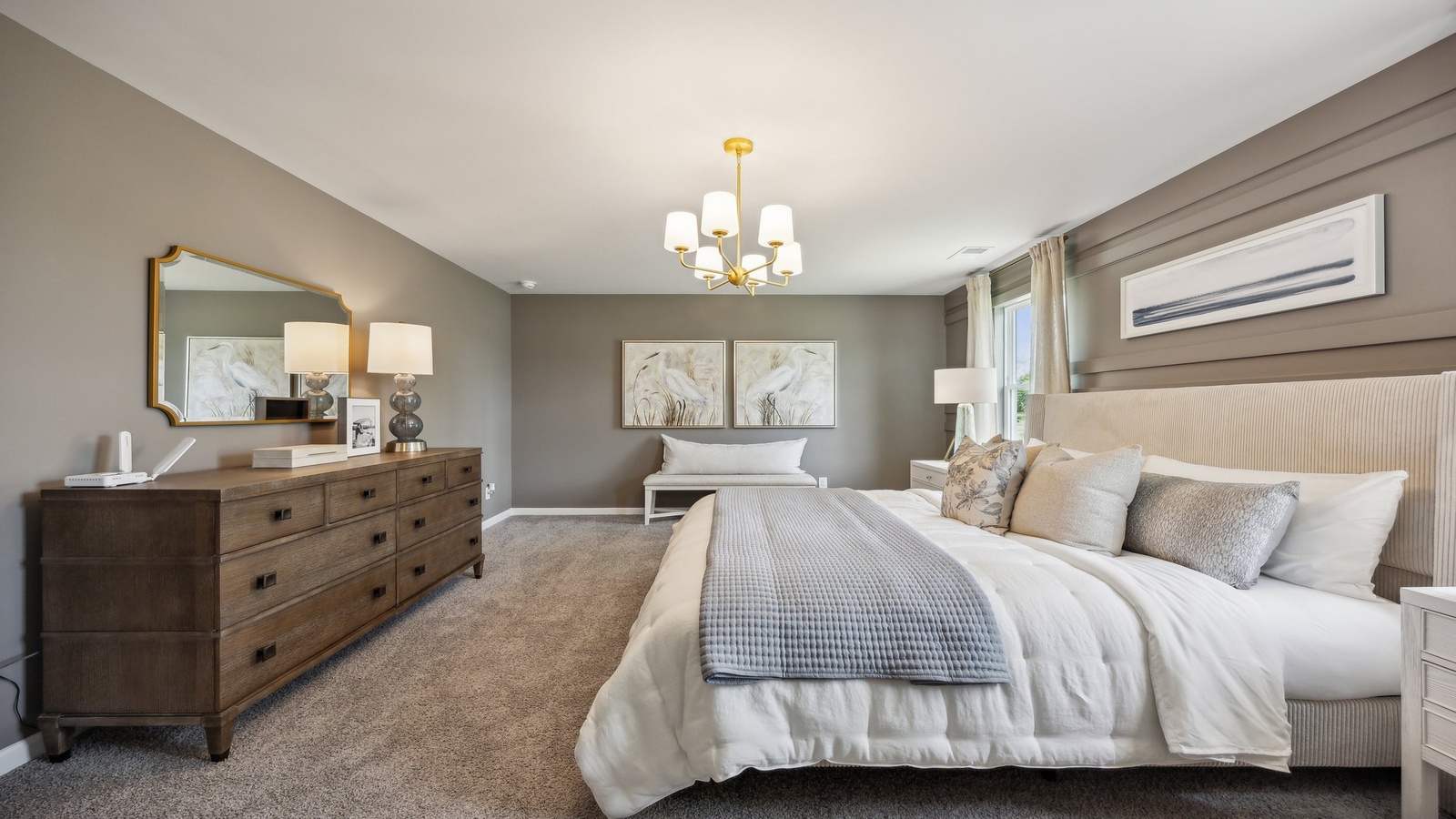 Primary suite at Green Spring Estates enjoys window views, walk-through access to spa-inspired ensuite bathroom, walk-in closet