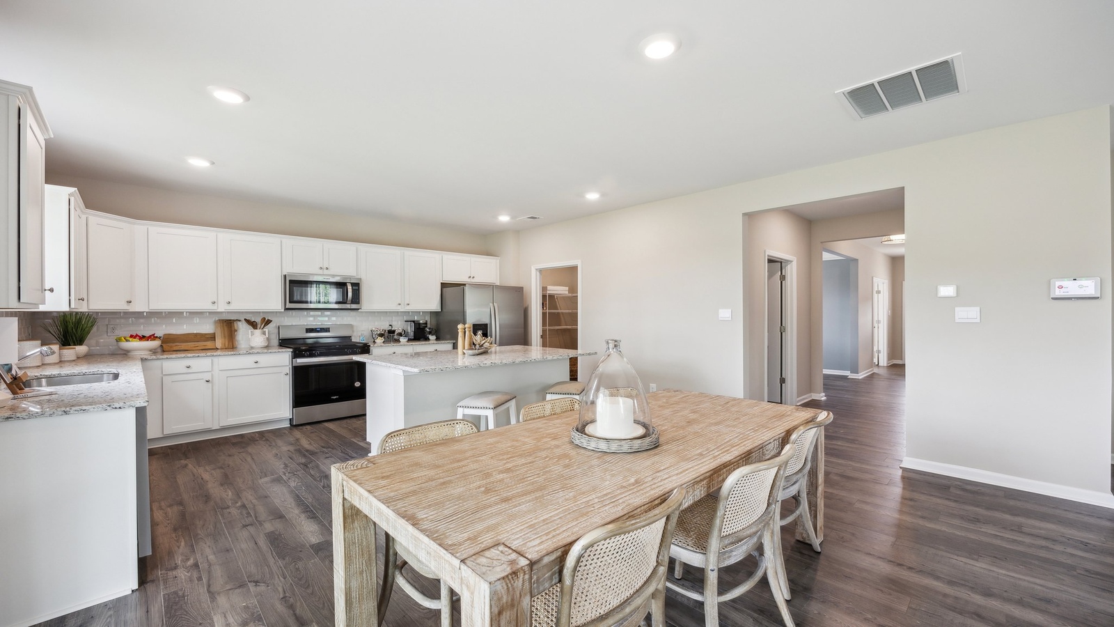 Central dining next to the kitchen, living areas, and a central easy flow to the residence