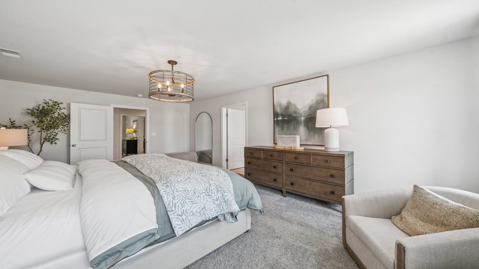 Spacious primary bedroom in our new construction home includes modern design finishes, quiet rear-facing windows