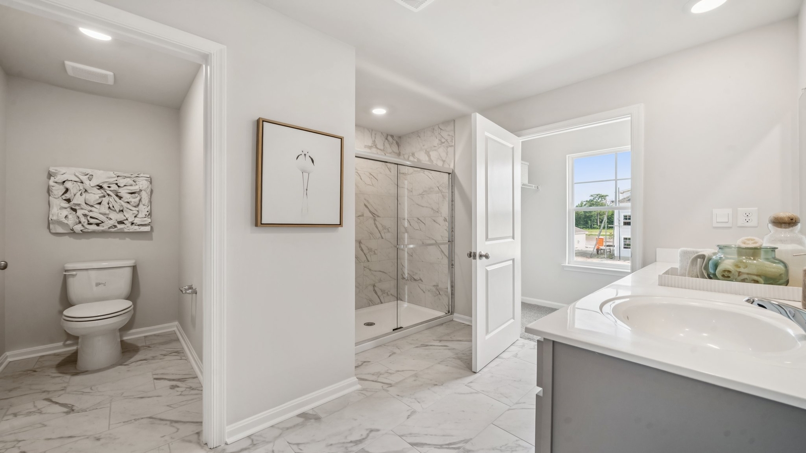 New home showcases a spa-inspired ensuite bathroom with quality upgrades, open design to shower-tub, and walk-in closet