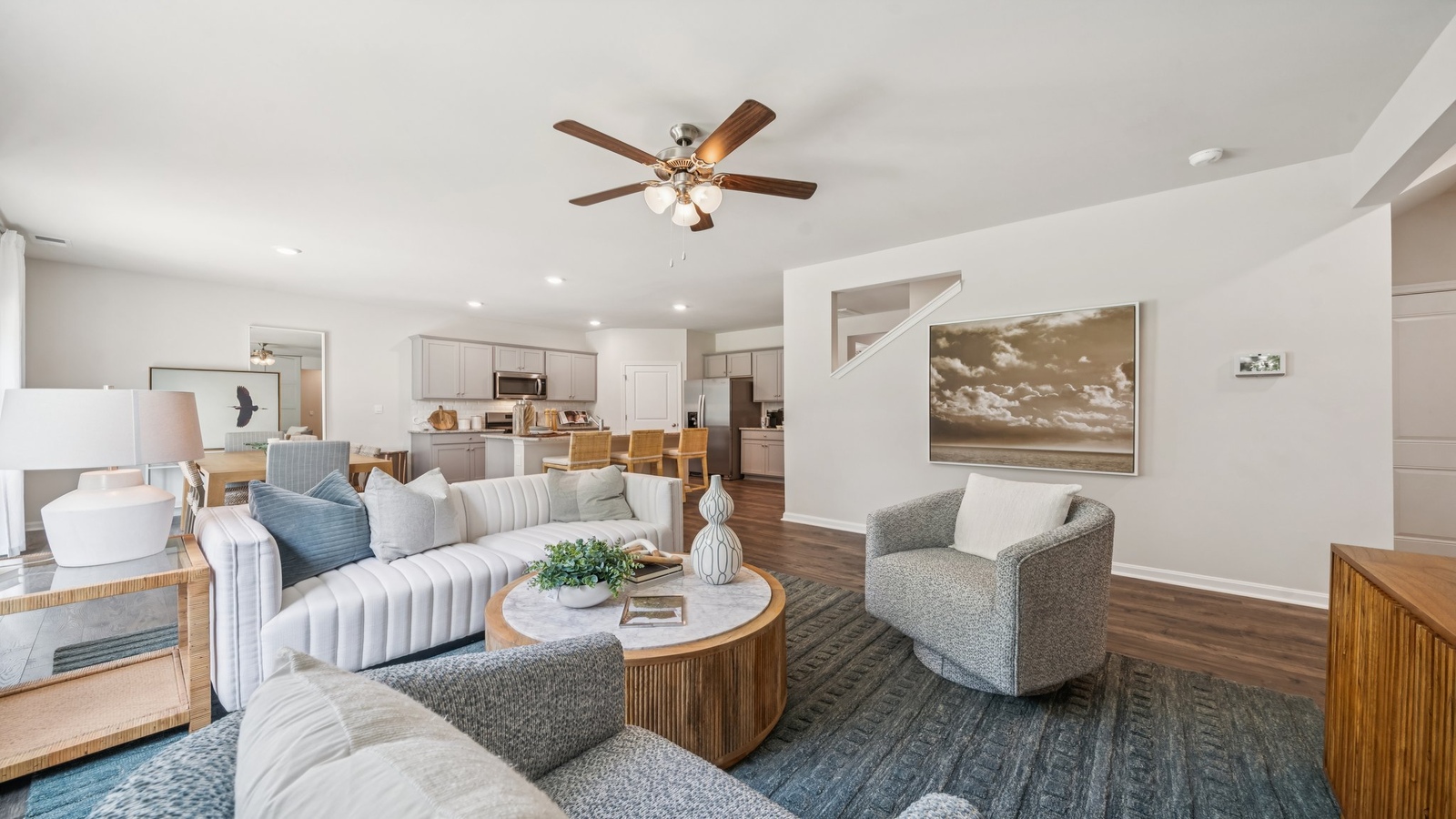 Functional layout with family room looking into modern kitchen and stairwell to upper bedrooms at Green Spring Estates