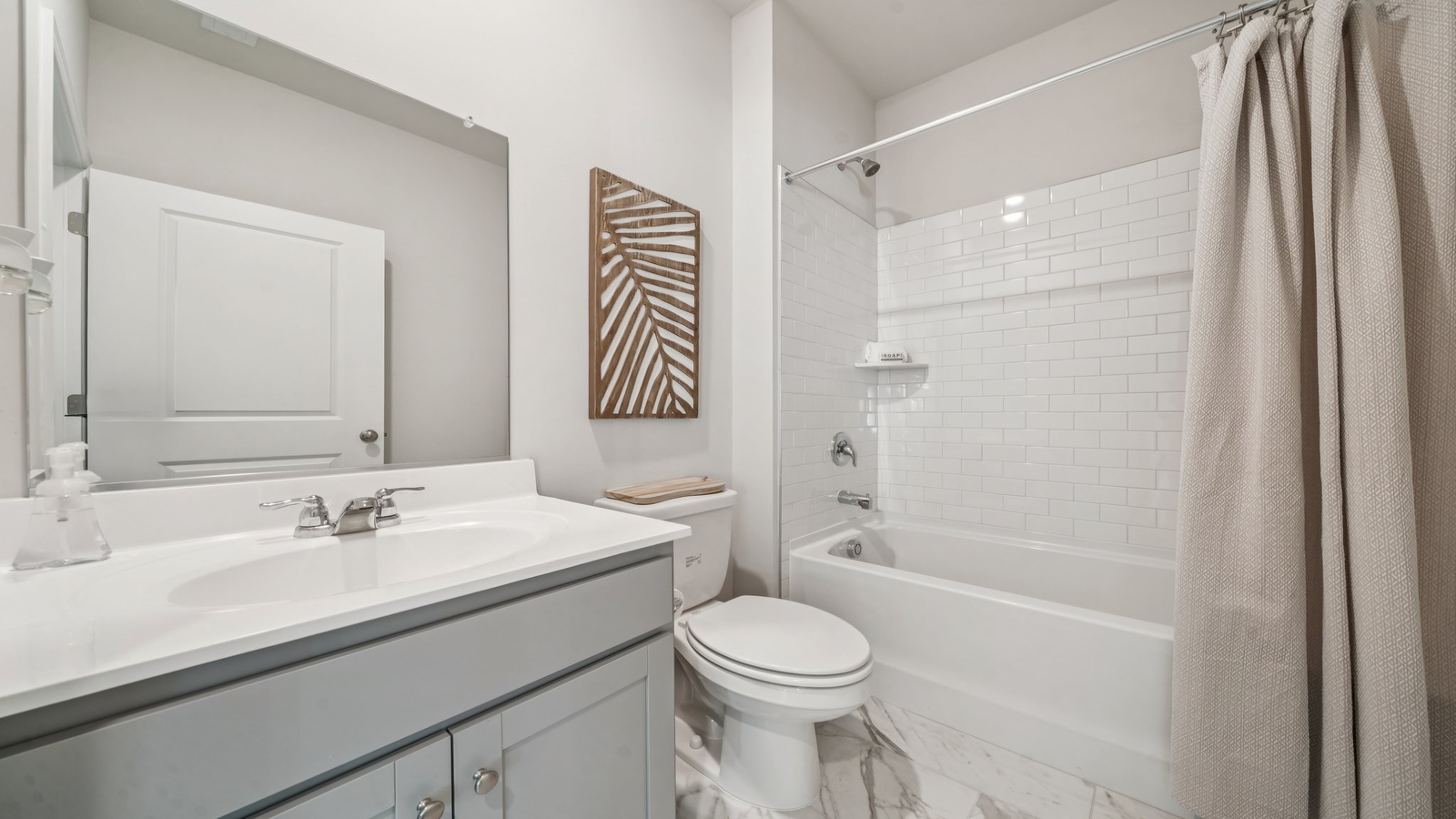 Full secondary bathroom with tub and shower combo, vanity, with fresh designs, storage at Green Spring Estates