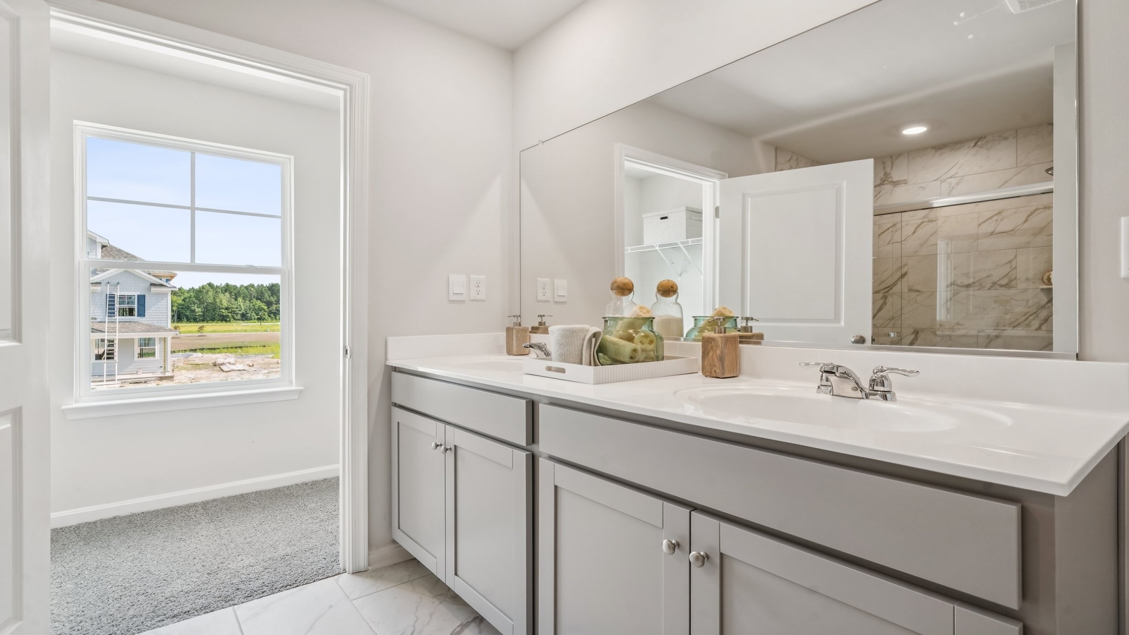 New construction home includes a thoughtful private ensuite, walk-in shower, walk-in closet, full vanity, mirror, backyard view