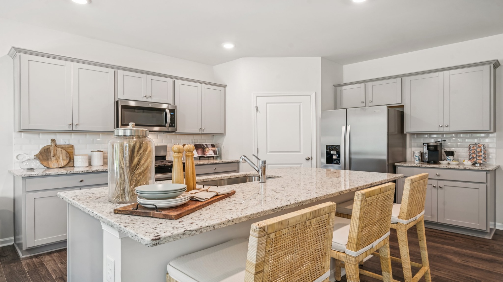 Spacious kitchen in this home features a bright layout, pantry, kitchen island with seating, and full new appliance package