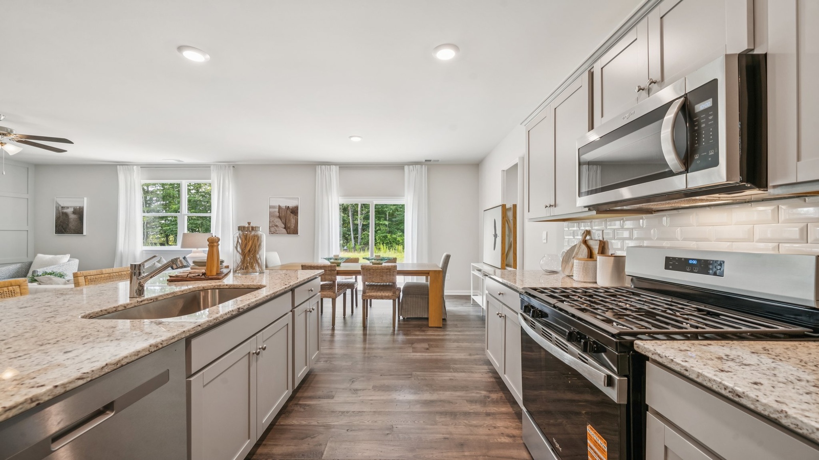 New appliances and larger island with seating anchor the kitchen, next to dining, family rooms provide open concept designs