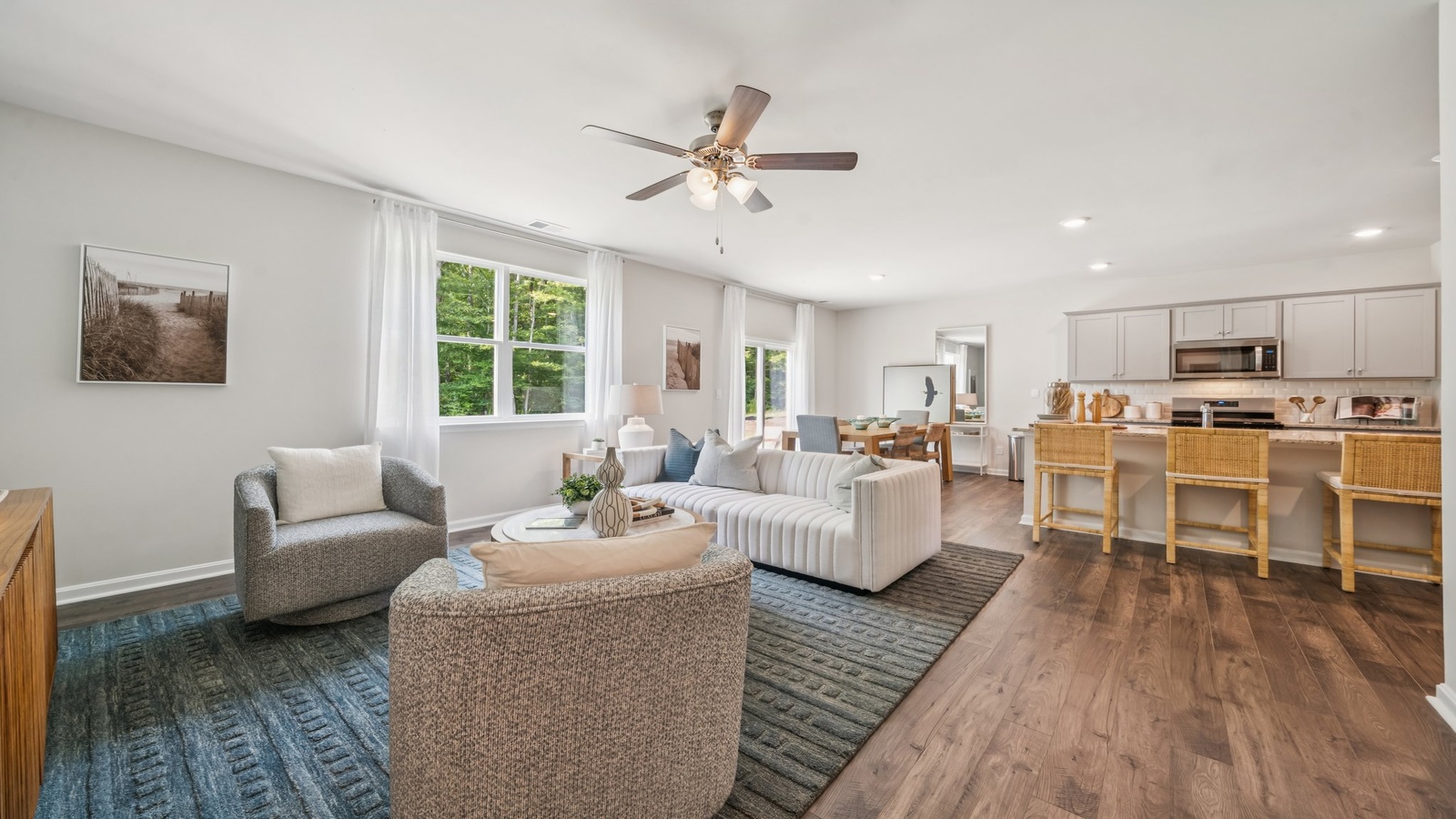Functional layout with family room looking into modern kitchen and stairwell to upper bedrooms at Green Spring Estates