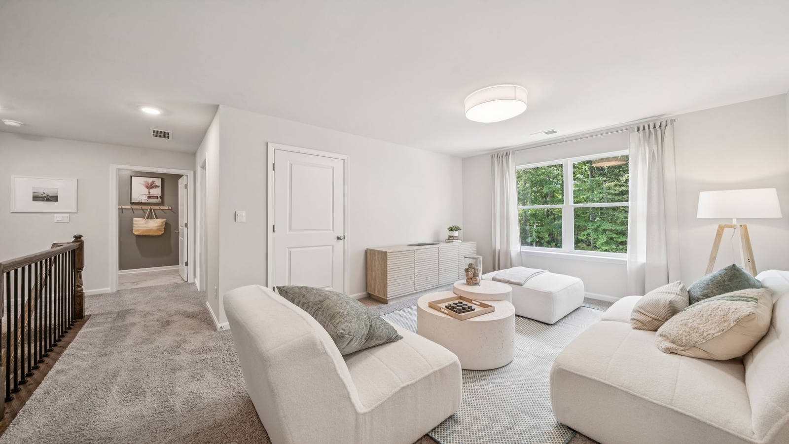 Upstairs loft access with a wide landing entrance, multi-use flow into bedrooms, bathroom, and stairs