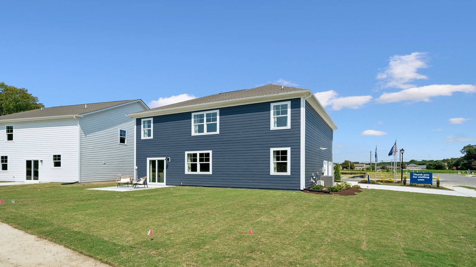 Backyard with concrete patio area offering room for seating, grill setup, and a transition from indoor to outdoor living