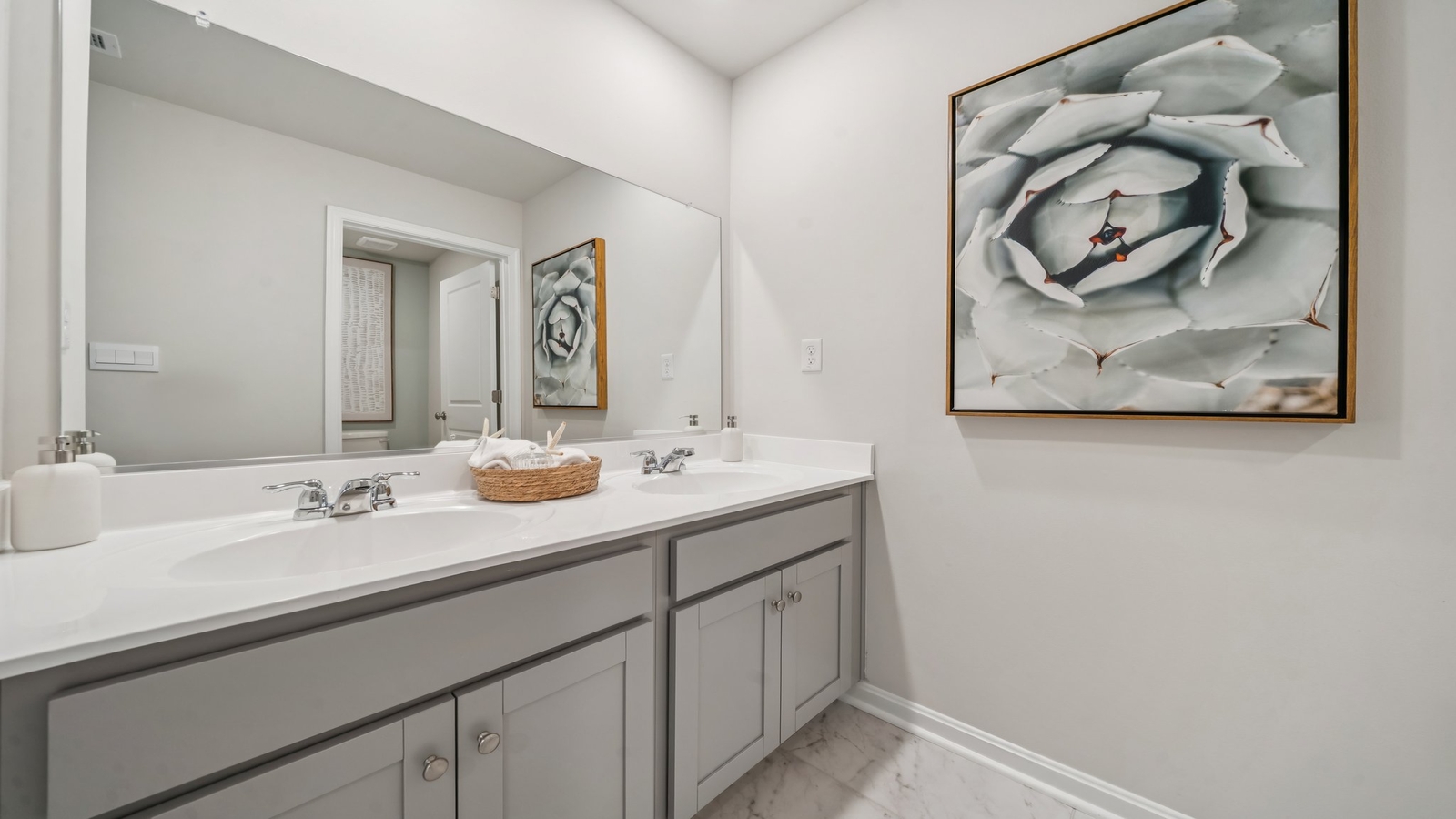 Family bathroom with quality vanity, tub-shower combo, storage in Green Spring Estates by D.R. Horton