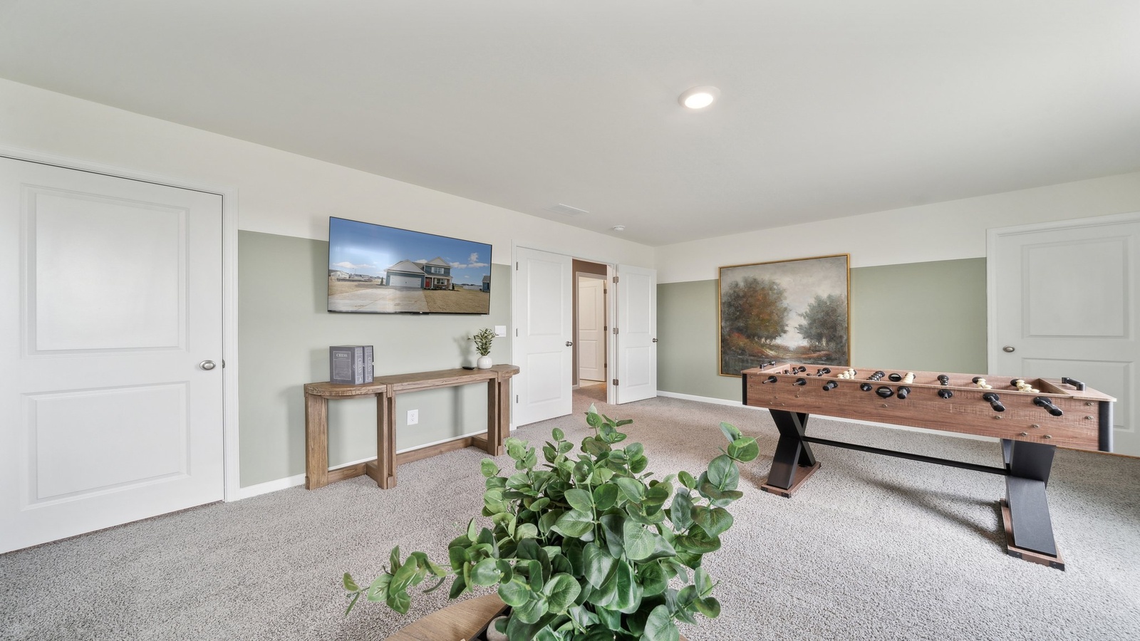 Upstairs loft with open hallway view into bedrooms, with family-friendly design for multi-use, remote work or media