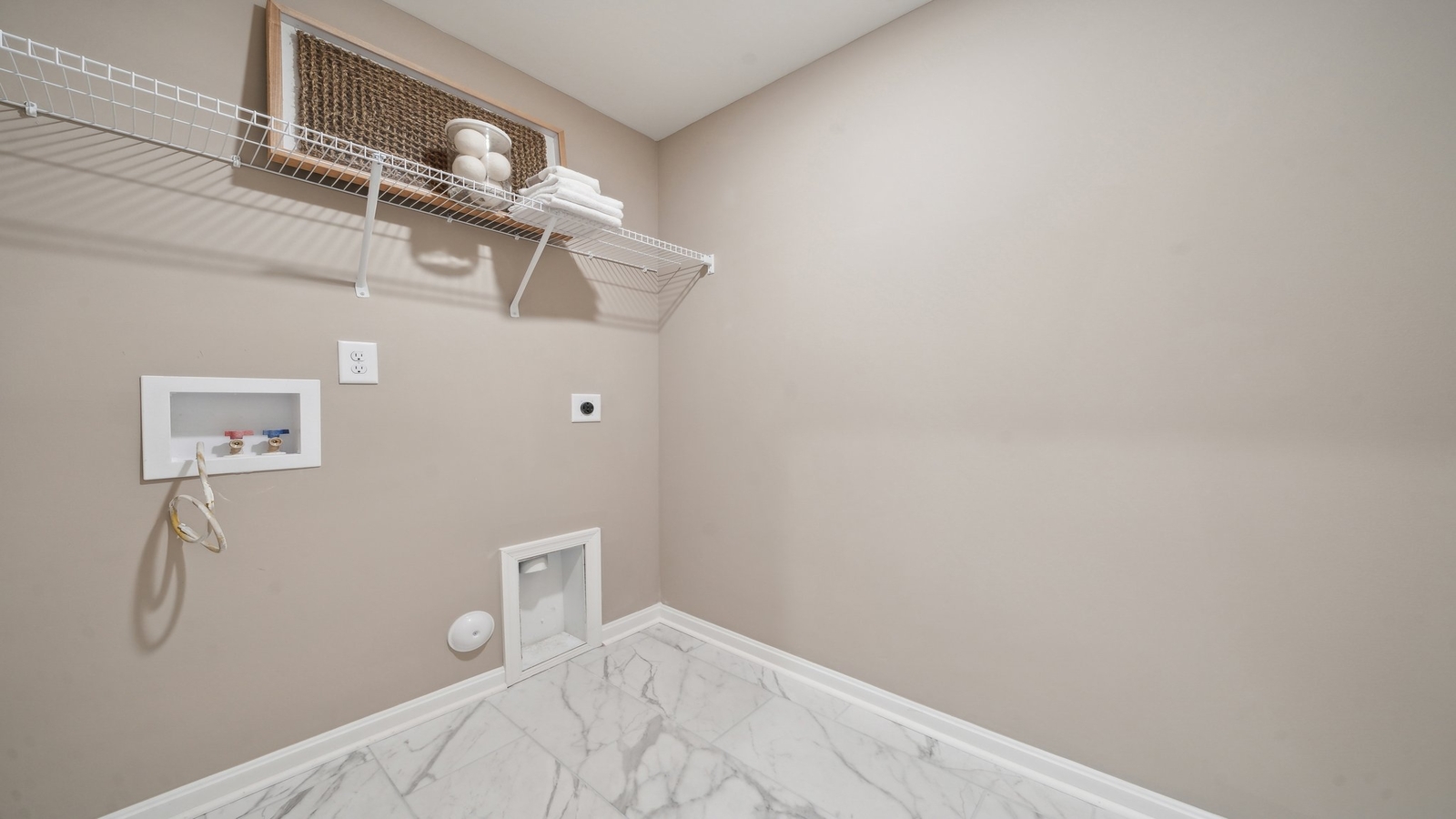 D.R. Horton designed laundry space at Green Spring Estates with new washer, dryer, upper cabinets for added space and functionality