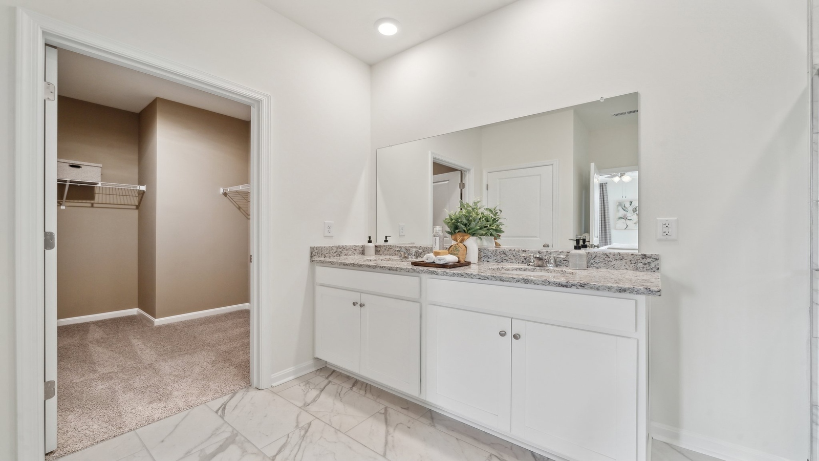 New construction home includes a thoughtful private ensuite, walk-in shower, walk-in closet, full vanity, mirror, backyard view
