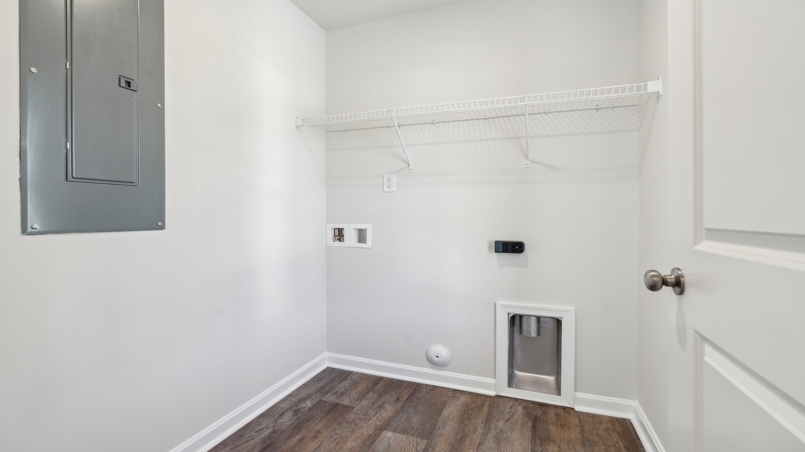 Springwood of Kilmarnock utility laundry room’s smartly designed overhead organized efficient storage, with new washer, dryer included