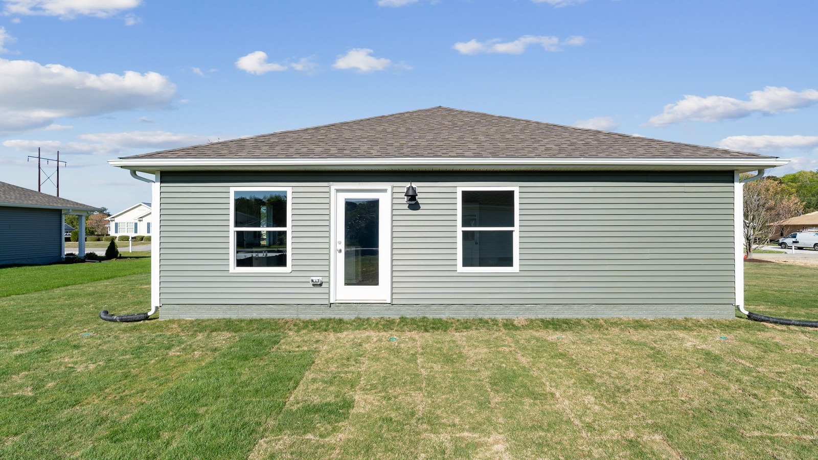 Backyard offering room for seating, grill setup, and a transition from indoor to outdoor living, grass yard