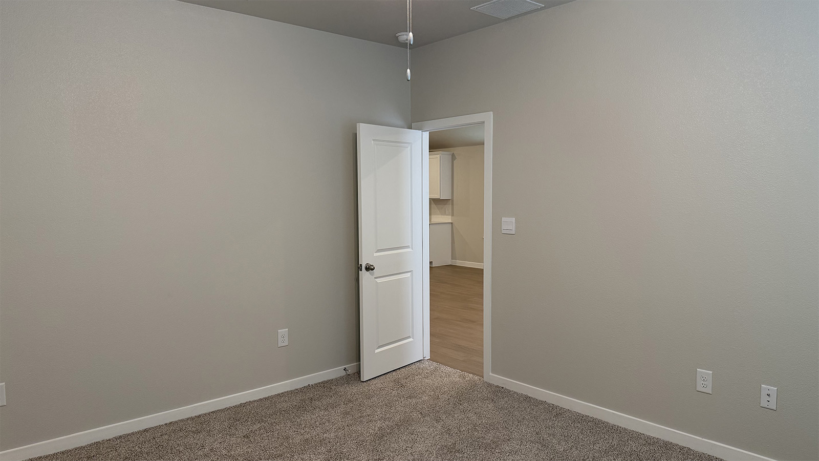 Primary bedroom features ample space, double windows, soft carpet, a stylish walk-in closet, and a private ensuite bath