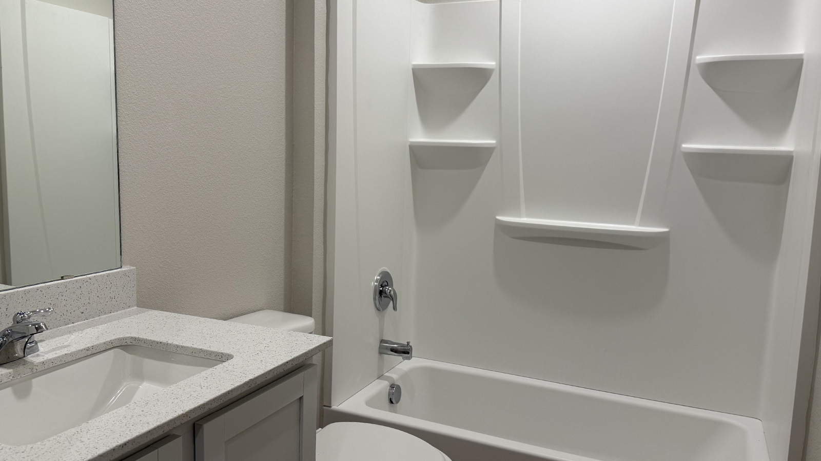 Secondary bath with built-in tub-shower combo, vanity, sink, lighting, stylish finishes in Shiloh Springs
