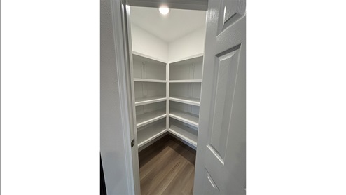 Corner pantry with wood shelving