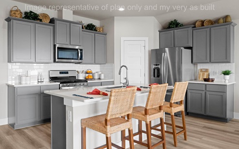 kitchen corner pantry and light gray shaker cabinets
