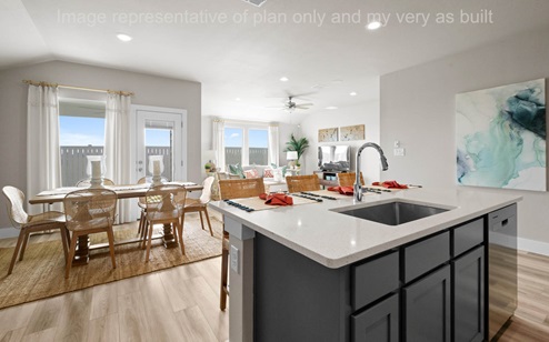 kitchen with island breakfast bar featuring white quartz counters