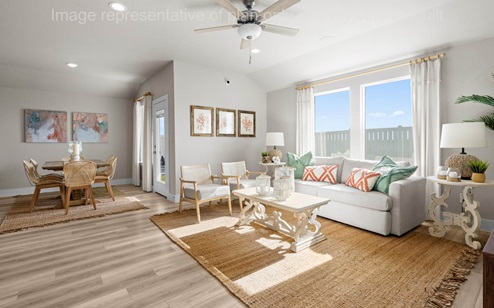 large living room with celling fan and EVP flooring overlooking backyard