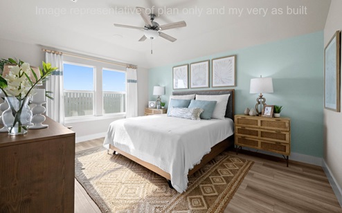 primary bedroom with celling fan and EVP flooring