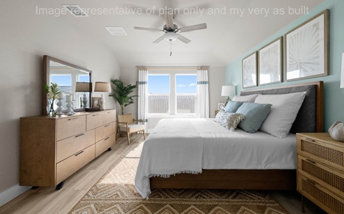 Primary bedroom with large window overlooking backyard
